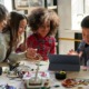STEM education program grants: diverse children work on STEM project at table