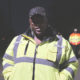 gun violence: Woman in yellow jacket, blue cap looks straight into camera