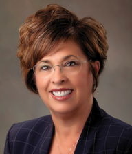 Chaplains in schools: Headshot woman with short brown hair in dark suit