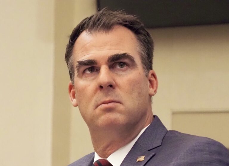 Oklahoma-strikes-down-religious-charter-school: Headshot of frowning white man with dark brown hair in gray suit with white shirt and dark tie