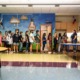 Texas schools are breaking bank to pay for teacher raises: students line up to walk behind teacher in front of colorful wall